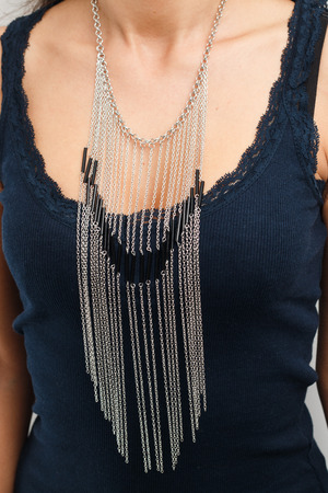 Woman's necklace on black leather mannequin shot with artificial lightingの写真素材