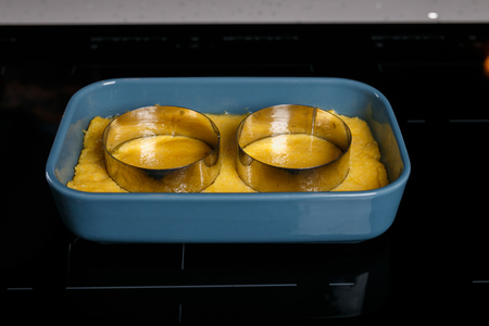 Polenta with cutting shapes on it in a blue bowlの写真素材