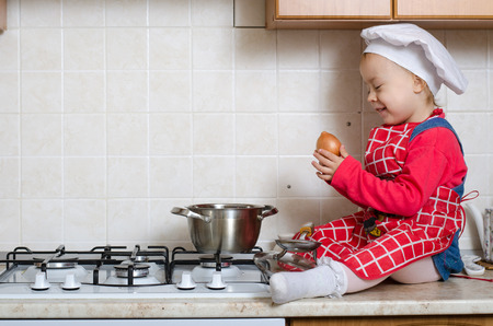 Little chef puts into the pot vegetablesの写真素材