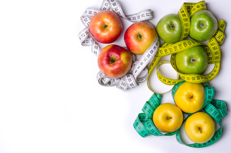 Concept of diet, apples with measuring tape isolated on white, top view. Healthy food, fresh apples on a white background.の写真素材