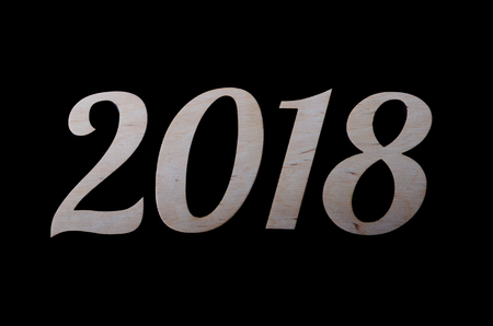 The inscription 2018 is isolated on a black background. New Year's background for your calendar.の写真素材