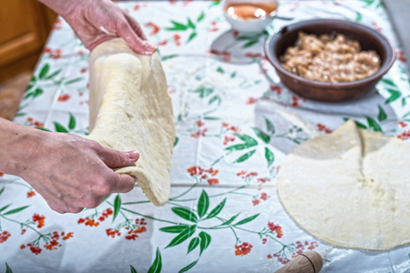 Female hands rolling out dough for homemade baking. Preparation of baking.の写真素材