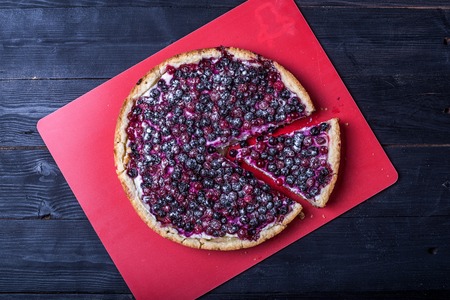 Delicious mascarpone cheesecake with currant on wooden table background, top view. Homemade cheese cake.の写真素材