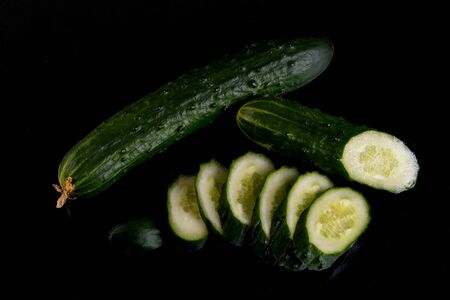 Cucumber slices against black backgroundの写真素材