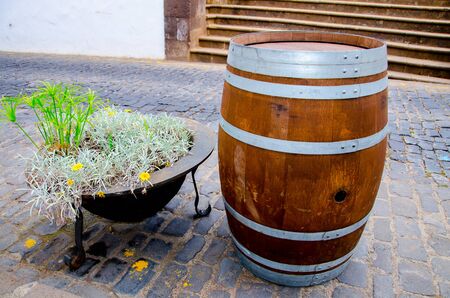 Wine barrel next to flower bedsの写真素材
