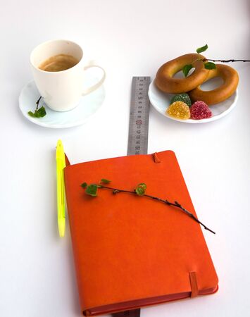Coffee, plate, bagels, marmalade, sprig with green leaves, notebook, linear on a white backgroundの写真素材