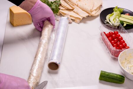 Round pita bread with cheese, cucumber, herbs, cherry tomatoes, mayonnaise. Cooking snacksの写真素材