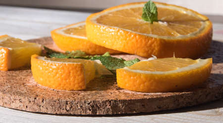 Orange slices, on a wooden table