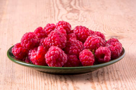 raspberries on wooden background