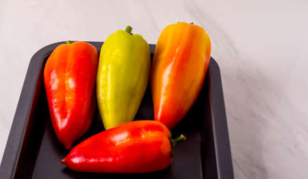 Red yellow and green pepper on a tray