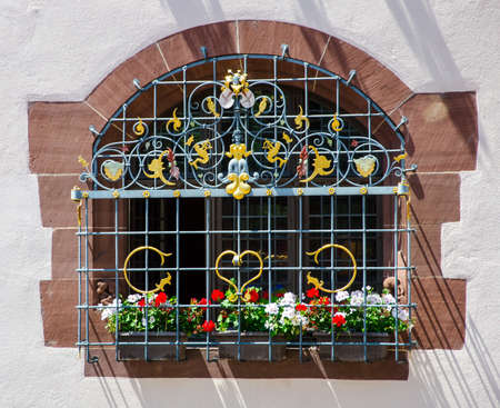 Window with flowers and wrought iron bars, Freiburg, Germany 07/19/2017のeditorial素材