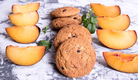 Shortbread and plum sliced with mint leaves