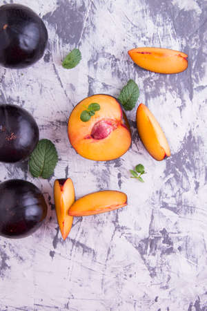 Plum whole and sliced, with the slices with mint leavesの写真素材