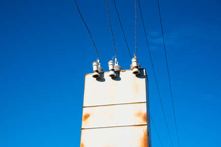 Old rusty transformer shield against the sky