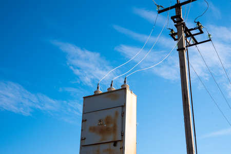 Old rusty transformer shield against the sky