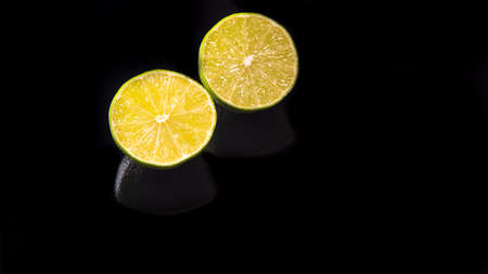 Lime halves on a black background close-upの写真素材