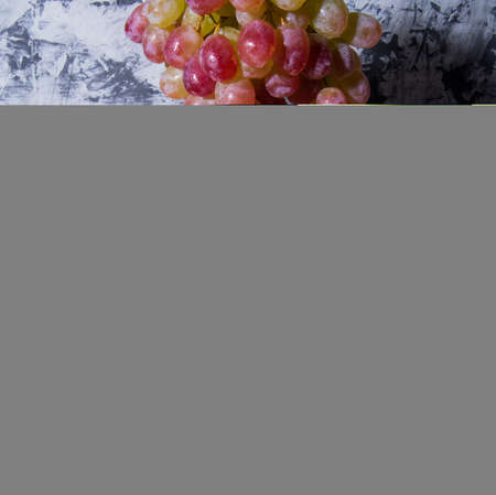 Bunch of grapes, lemon, orange on black and white background, close - up, with space for text, background, postcard, Wallpaper,の写真素材
