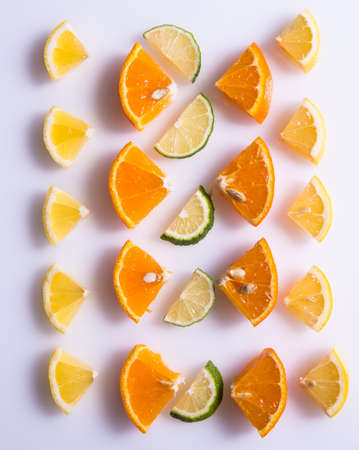 Lemon, orange, lime slices on a white background, isolated, creative layout, space for text, top viewの写真素材