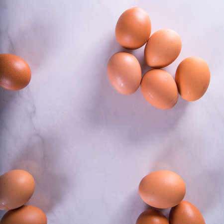 Close-up of fresh brown eggs, top view, copy space, background, advertisingの写真素材