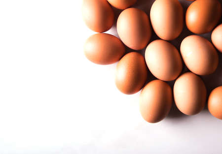 Close-up of fresh brown eggs, top view, copy space, background, advertising
