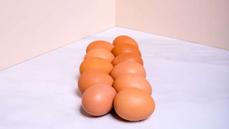 Close-up of fresh brown eggs, in one line, side view, copy space, background, advertising