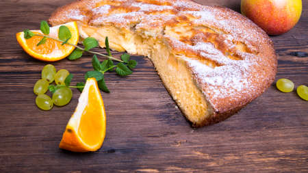 Charlotte, Apple pie with mint sprigs, orange slices and Apple on a wooden table, copy space, close-up, photos, Wallpaperの写真素材