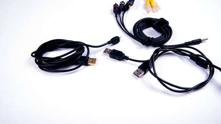 Different cables for connecting different connectors for connecting electronic boards, audio and video inputs, isolated, copy space, on a white background, close-upの写真素材