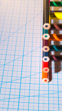 Color pencils with hard shadows on the cutting Mat, in a low key, copy space close-up, side viewの写真素材