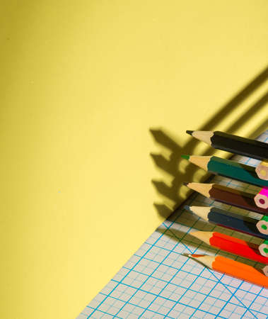 Color pencils with hard shadows on the cutting Mat, in a low key, copy space close-up, side viewの写真素材