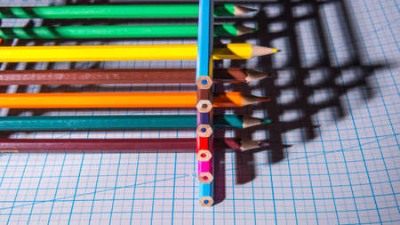 Color pencils with hard shadows on the cutting Mat, in a low key, copy space close-up, side viewの写真素材