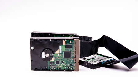 Hard drives management scheme for storing information are connected by a cable HDD Cable on a white...