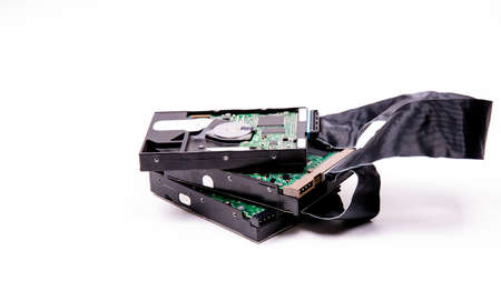 Hard drives management scheme for storing information are connected by a cable HDD Cable on a white...