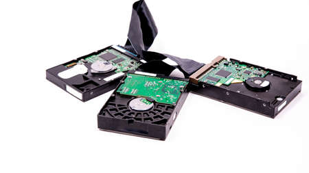 Hard drives management scheme for storing information are connected by a cable HDD Cable on a white...
