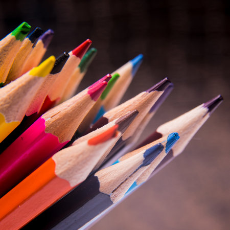 Colored pencils on a dark background stacked, close-upの写真素材