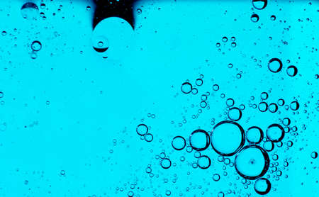 Oil bubbles on the water surface in motion, on a turquoise background, macro, splash screen,...