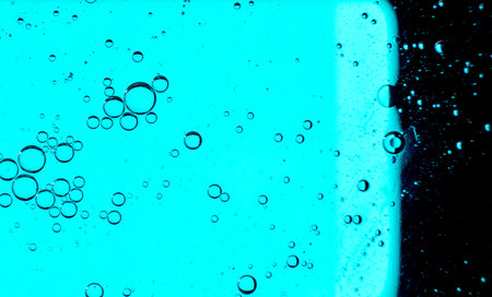 Oil bubbles on the water surface in motion, on a turquoise background, macro, splash screen,...