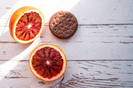 Red orange halves cookies with chocolate icing, close-up, copy space, template, postcard, background, macro photographyの写真素材