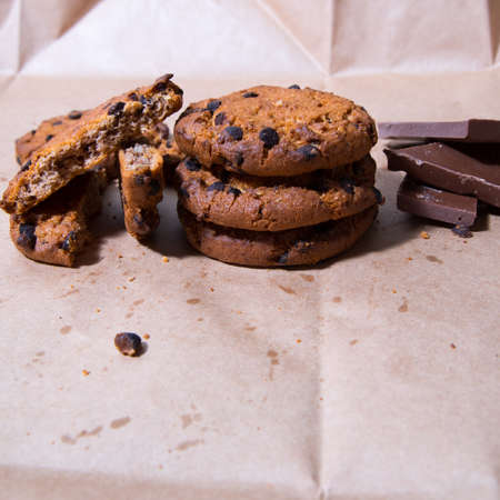 Cookies with chocolate icing, on gray packaging paper, copy space, template