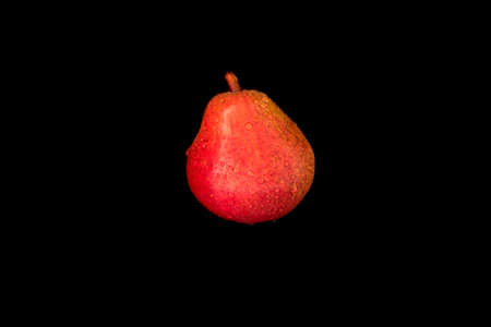 Red pear with water drops on black background, close-up, copy space, template,の写真素材
