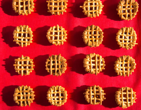 Cookies with red jam and tablecloth close-up, top view, copy space, patternの写真素材