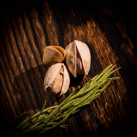 Pistachio nuts with rosemary on wooden background,top view,copy spaceの写真素材