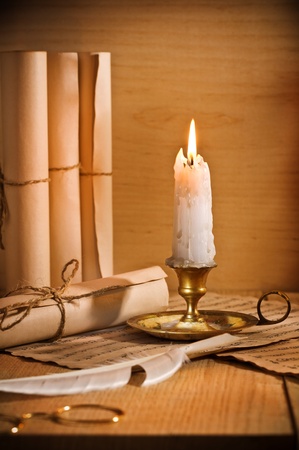 antic candle with rool of paperの写真素材