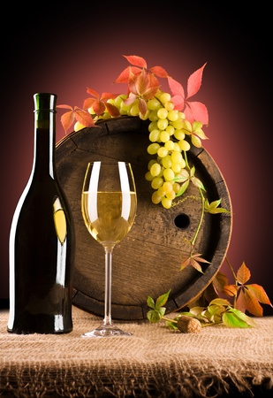 composition of white wine and grape and foliage of grapeの写真素材