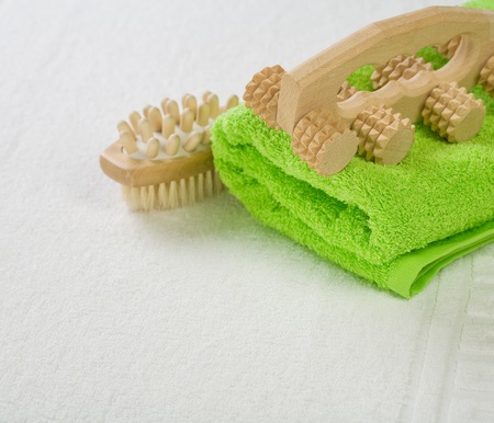 brush and massager with green towelの写真素材
