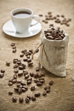 coffee beans and cup of coffee on sacking の写真素材