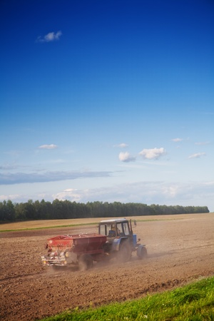 tractor on the cultivated fieldの写真素材