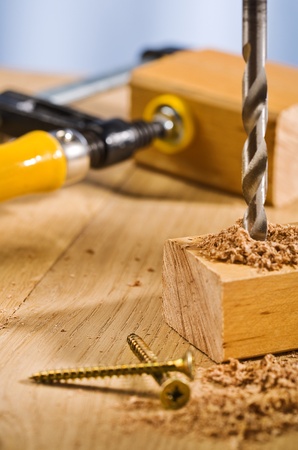 Drilling hole in a wooden plank の写真素材
