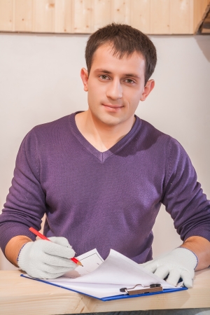 contractor with pencil drawing in blueprintの写真素材