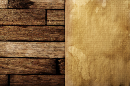 Ancient paper on a brown wooden surface.の写真素材