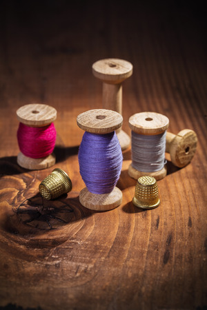 vintage sewing items on old wooden board